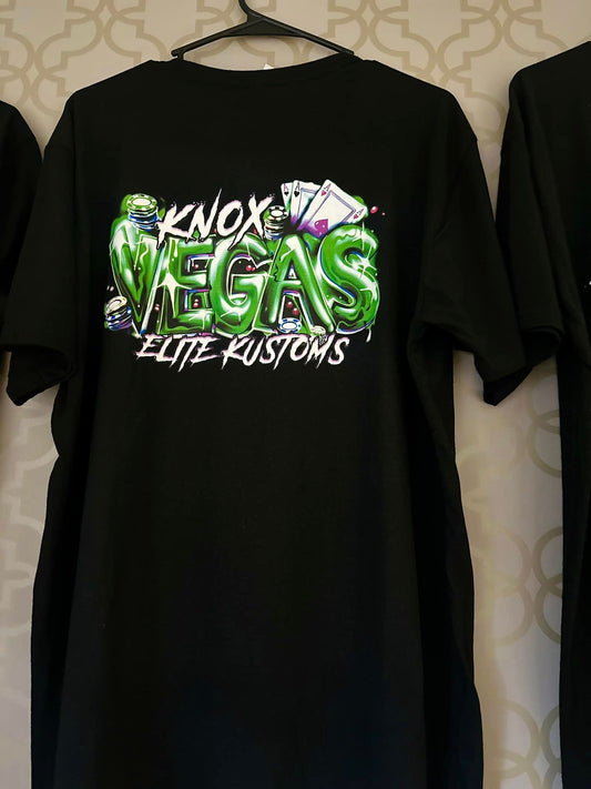 Black t-shirt with 'Knox Vegas Elite Kustoms' graphic design on a patterned wall background